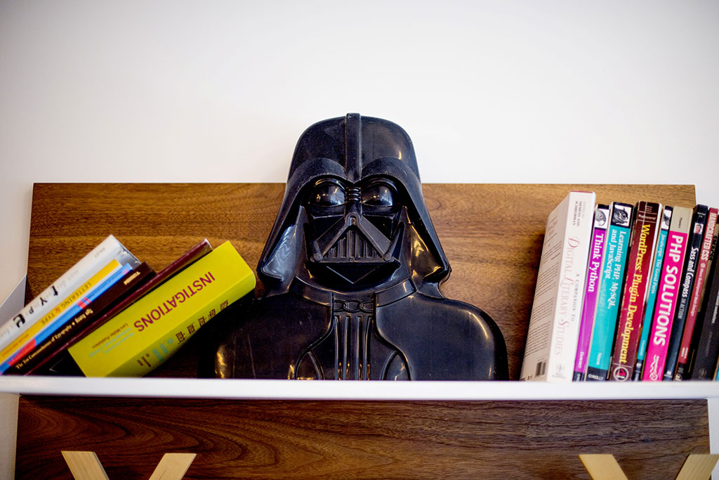 Darth Vader sits on a bookshelf at Upstatement