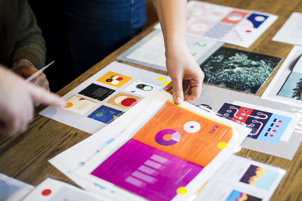 Moodboard images being arranged on a table
