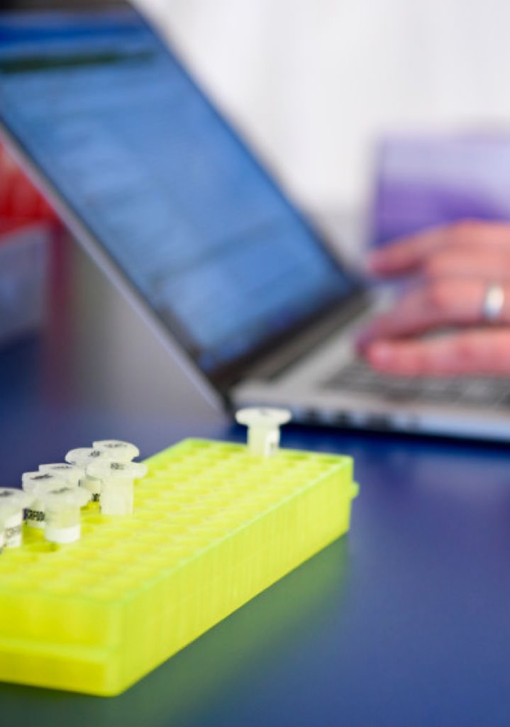 Lab tech records sample information on a laptop