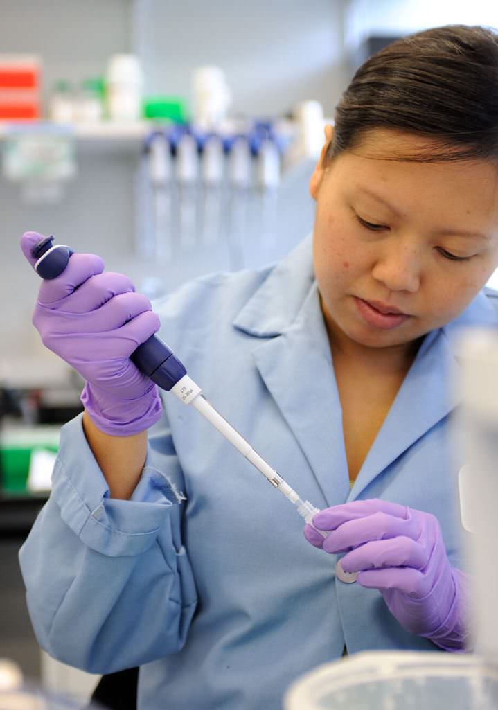 Lab tech using a pipette